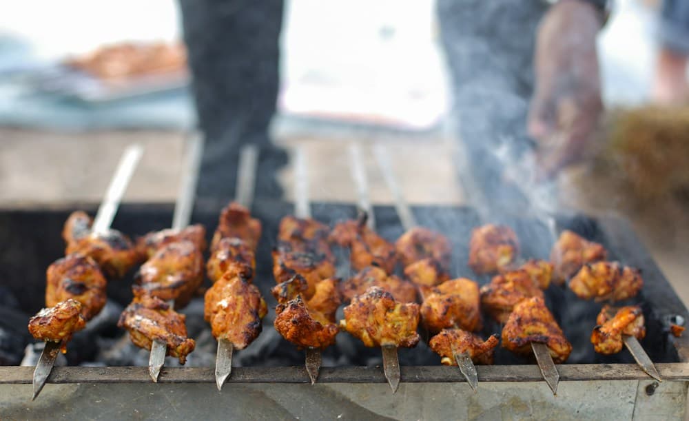 Kebabs cooking on a charcoal grill