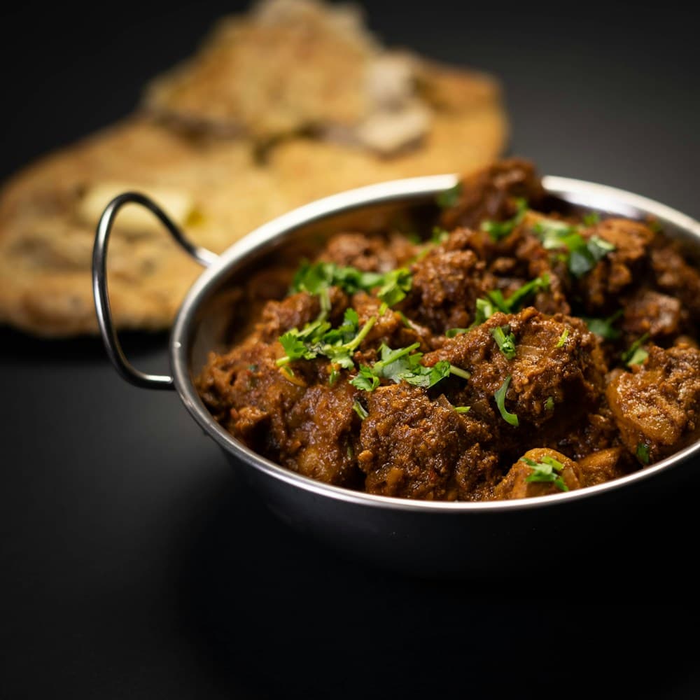 Lamb curry in a steel karahi